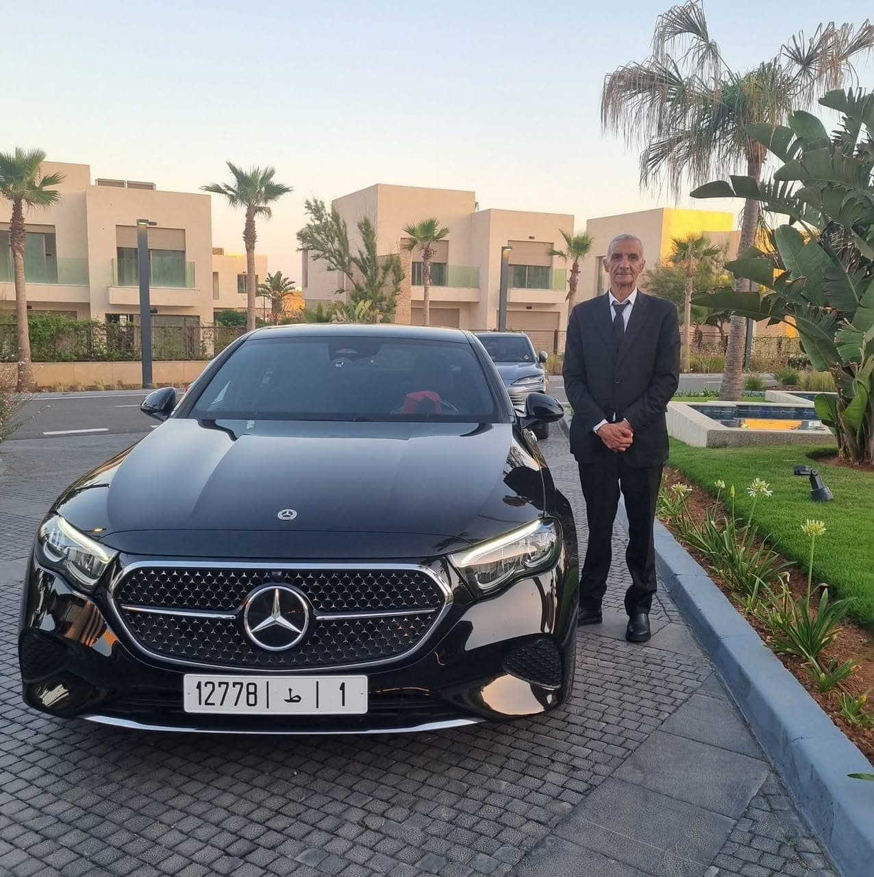 Marassa Sky Tours chauffeur beside a black Mercedes saloon in Morocco