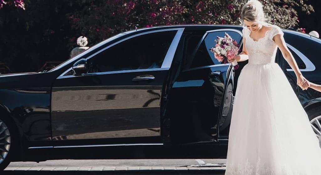 Decorated luxury wedding car with chauffeur